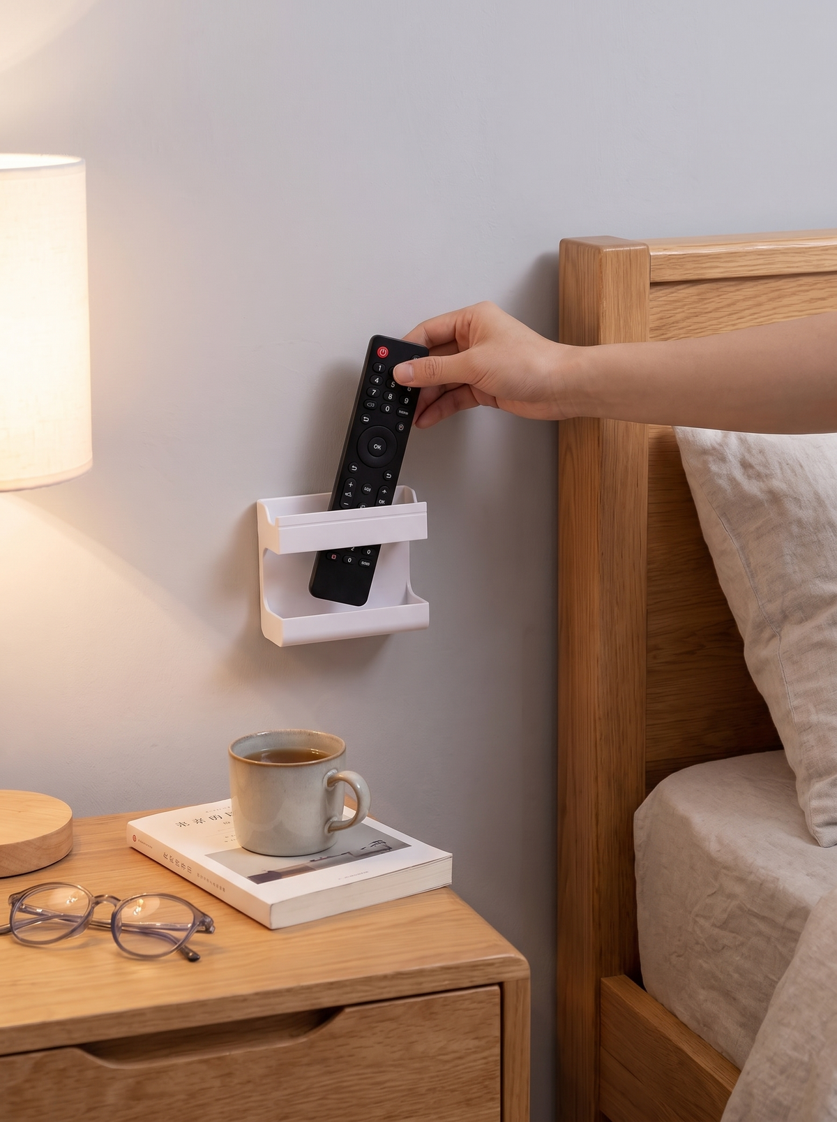 Wall mounted holder giving remotes a fixed place beside the sofa