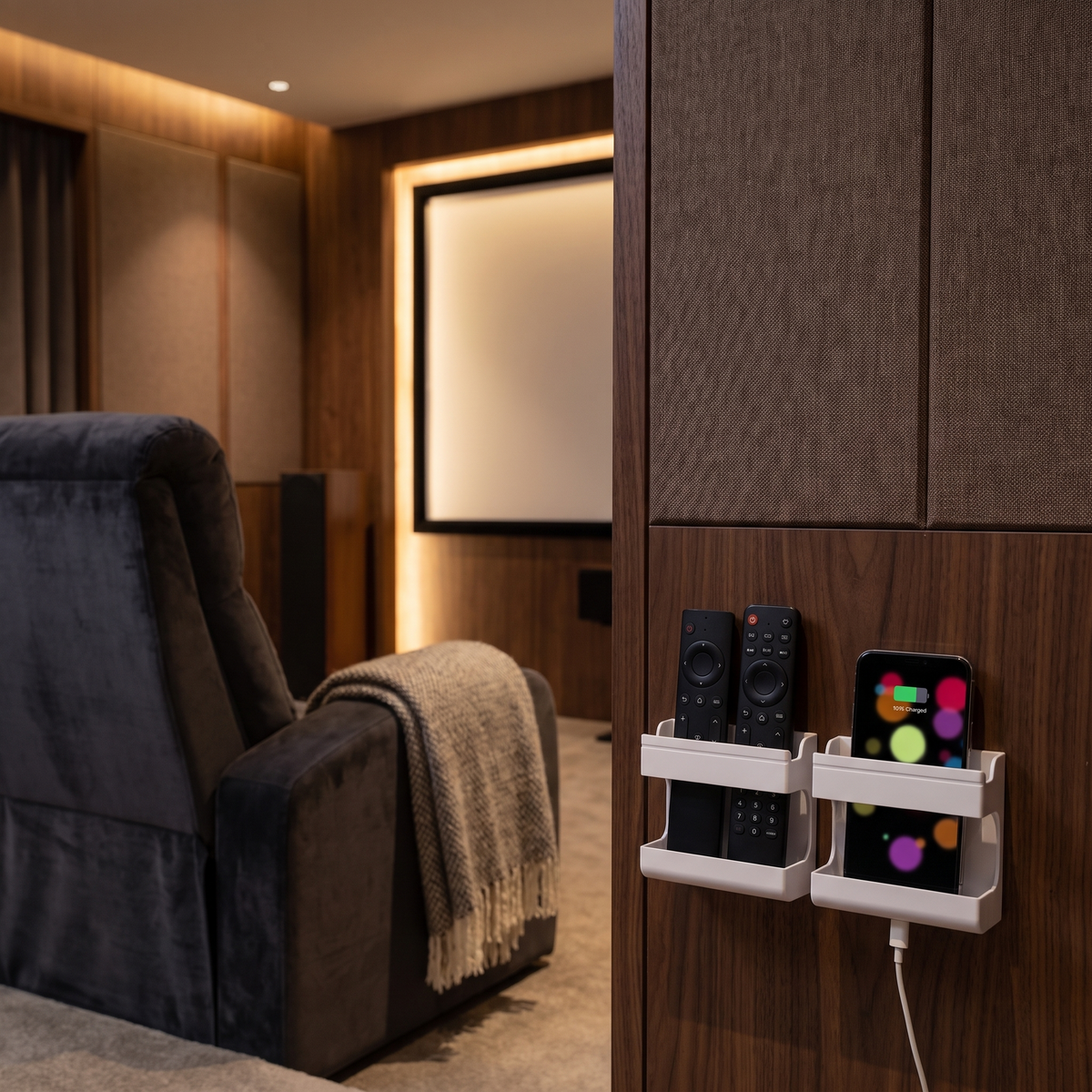 Wall-mounted remote and phone holder in a home cinema room