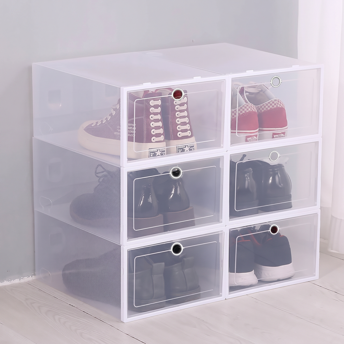 Six clear stackable shoe boxes clipped into a column against a wall