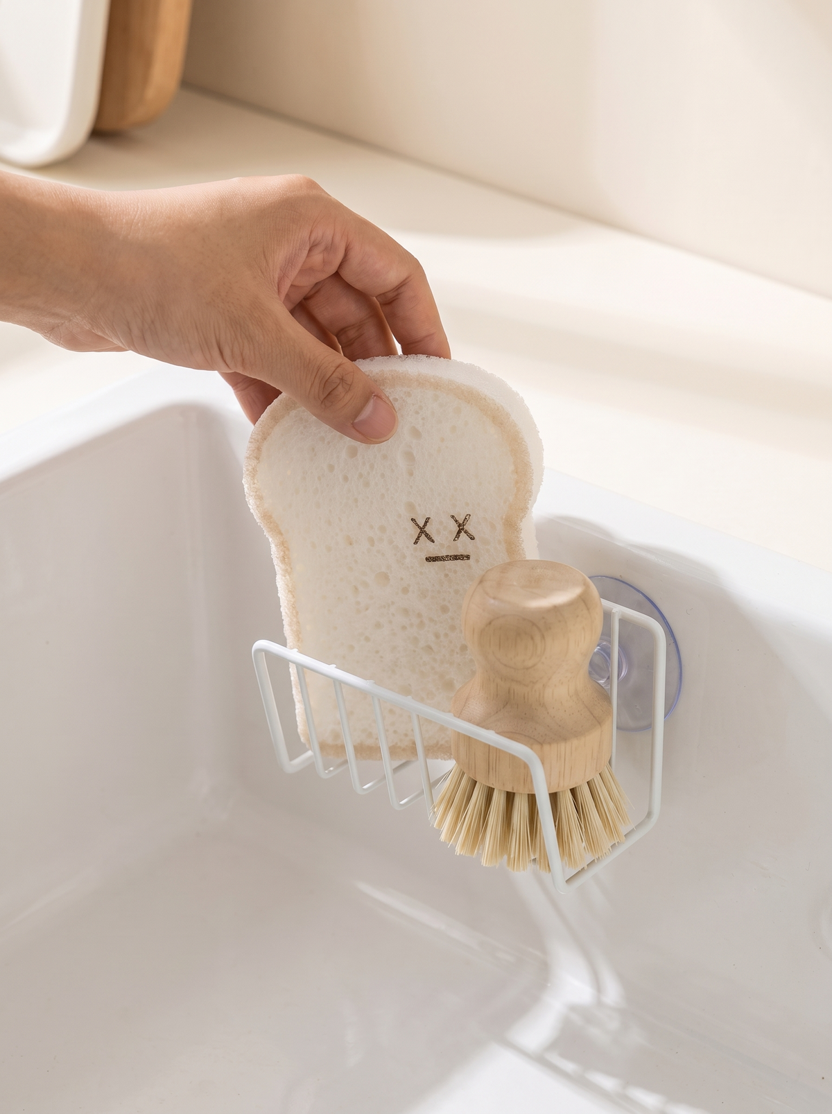 Suction cup sponge caddy inside a kitchen sink