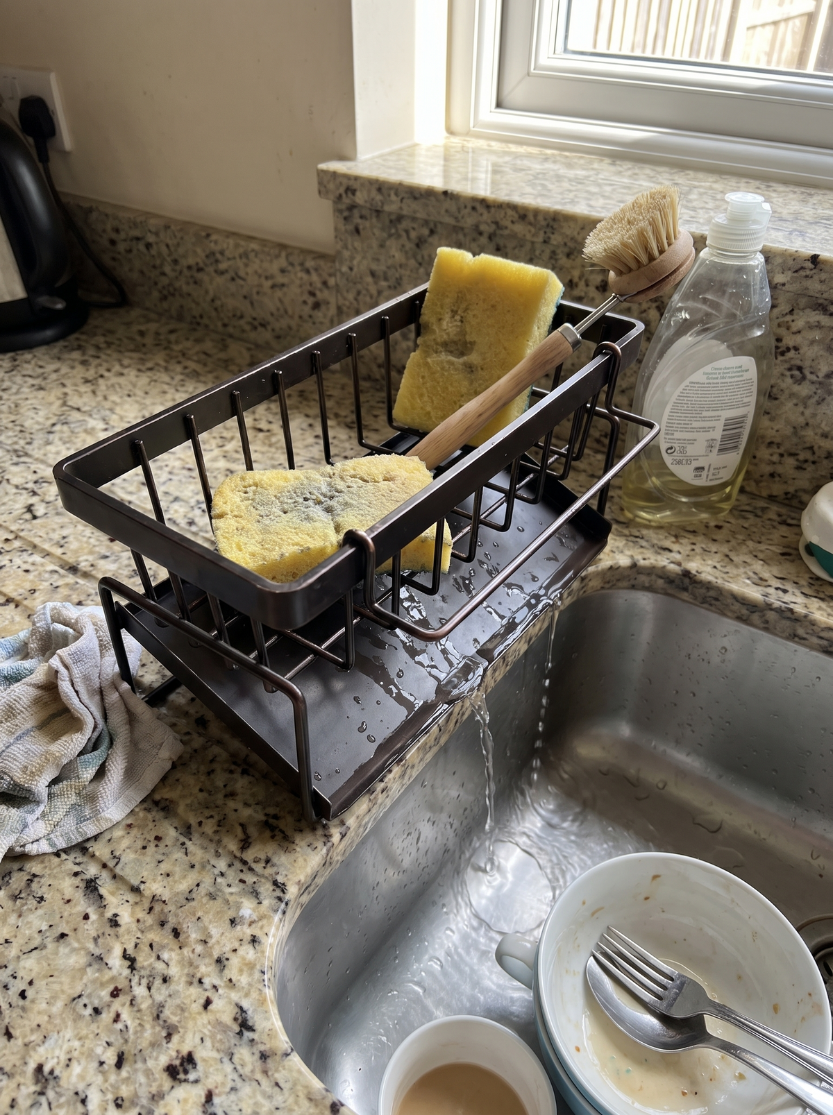 Water draining from the sponge shelf